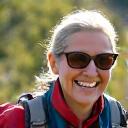 Smiling woman, Sarah, 58, hiking in Boulder mountains.