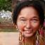 Profile photo of Maria P., a Hispanic woman in her early 50s with a kind, confident smile, outdoors.