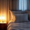 Comfortable bedroom scene with soft lighting, indicating restful sleep optimization strategies.